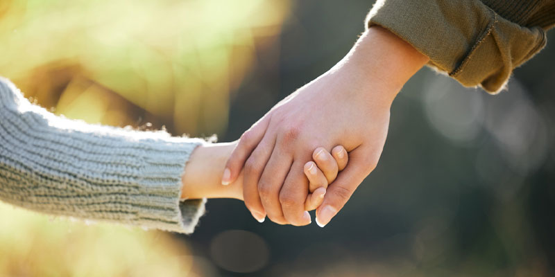 mom and child holding hands