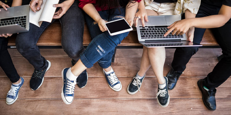 students using laptops, ipad and notebook